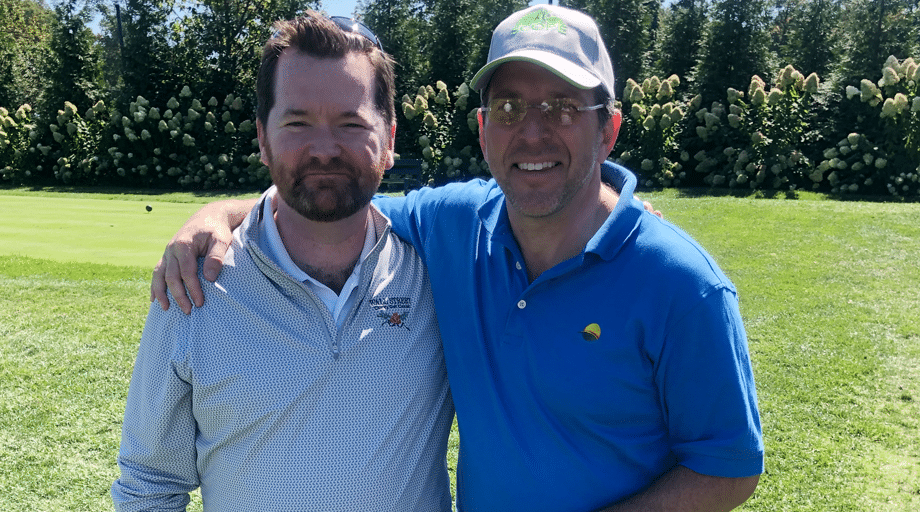 two men smiling at golf course