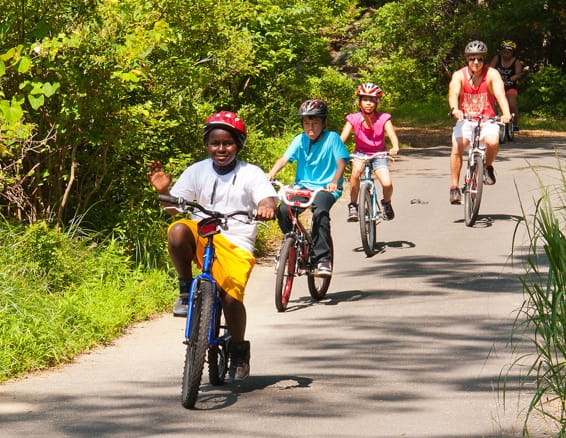 campers biking on road