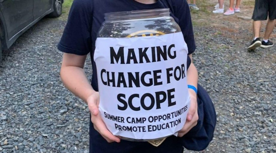 hands holding bucket labeled "Making Change for Scope"