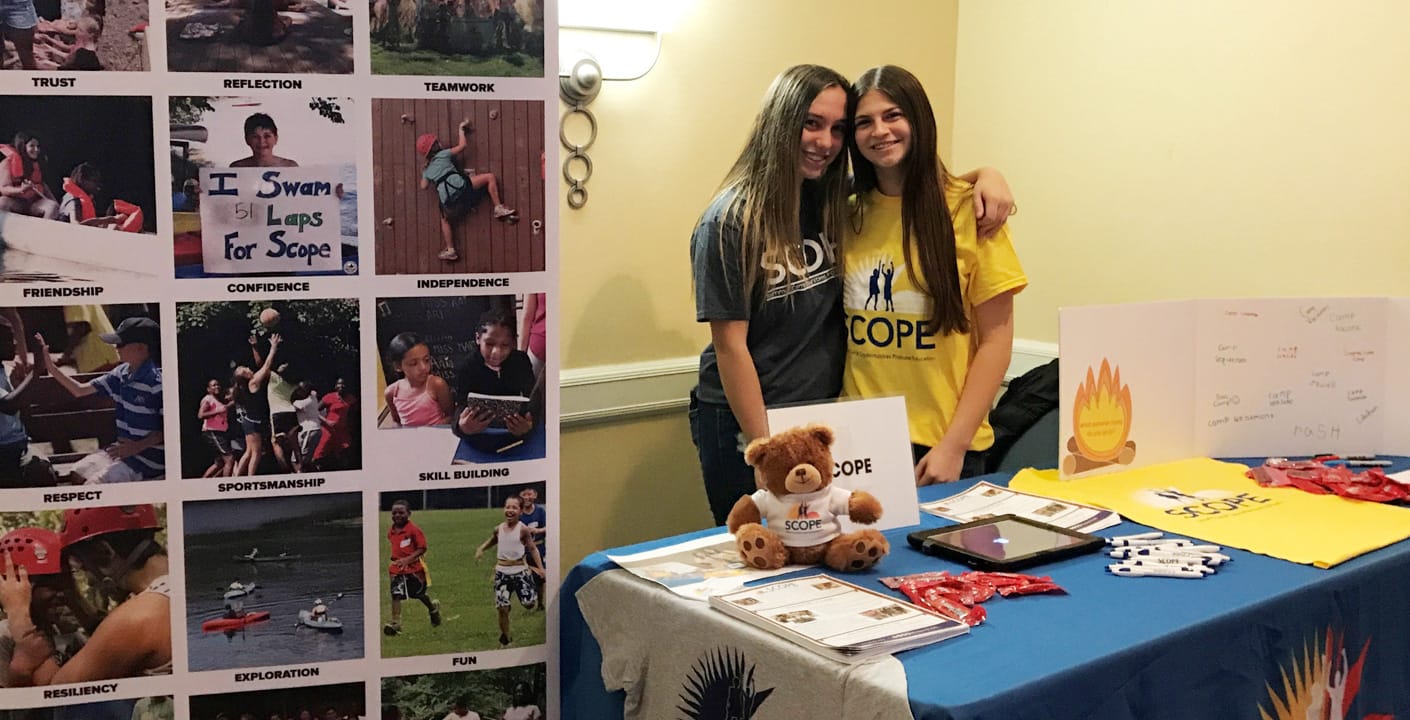 Two girls tabling for volunteering event