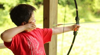 Camper shooting archery arrow