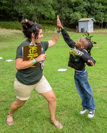 camp counselor giving kid high five