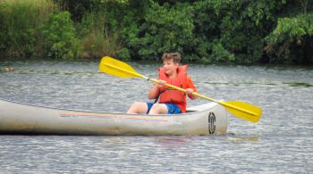 Camper canoeing at YMCA of the Pines
