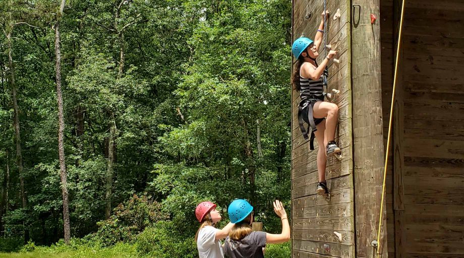 Girls at YMCA of the Pines on the climbing tower